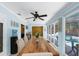 Dining room with a view of the backyard pool, wood table, and a ceiling fan at 1430 Rosetree Ct, Clearwater, FL 33764