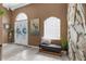 Foyer with natural stone accent wall and unique glass-block window at 1430 Rosetree Ct, Clearwater, FL 33764