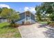 Charming home with a stucco exterior, stone accents, well-maintained landscaping, and a spacious driveway at 1430 Rosetree Ct, Clearwater, FL 33764
