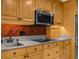 Spacious kitchen features a stainless steel microwave, granite counters, and wood cabinetry at 1430 Rosetree Ct, Clearwater, FL 33764