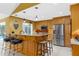 Spacious kitchen boasts a large island with seating, stainless steel appliances, and tile flooring at 1430 Rosetree Ct, Clearwater, FL 33764