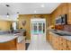 Bright kitchen features granite countertops, wood cabinetry, stainless steel appliances, tile floors, and pool access at 1430 Rosetree Ct, Clearwater, FL 33764