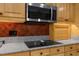 Close-up of modern kitchen appliances and granite countertops with red backsplash at 1430 Rosetree Ct, Clearwater, FL 33764