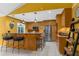Bright kitchen with stainless steel appliances, wooden cabinets and barstool seating at 1430 Rosetree Ct, Clearwater, FL 33764