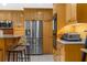 Kitchen features stainless steel refrigerator, wooden cabinets, and ample countertop space at 1430 Rosetree Ct, Clearwater, FL 33764