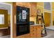 Kitchen features a built-in oven, wooden cabinets and view of a breakfast room at 1430 Rosetree Ct, Clearwater, FL 33764