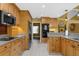 Well-equipped kitchen with wood cabinets, stainless steel appliances, and granite countertops at 1430 Rosetree Ct, Clearwater, FL 33764
