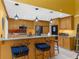Bright kitchen with stainless steel appliances, wooden cabinets, granite counters and barstool seating at 1430 Rosetree Ct, Clearwater, FL 33764