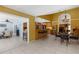 Open concept kitchen and dining area with wooden cabinets, tile floors, and pendant lighting at 1430 Rosetree Ct, Clearwater, FL 33764