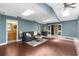 Spacious living room with skylights, an adjacent bathroom and a bar area for entertaining guests at 1430 Rosetree Ct, Clearwater, FL 33764