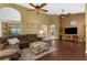 Spacious living room with laminate floor, ceiling fans, and comfortable sofa at 1430 Rosetree Ct, Clearwater, FL 33764