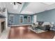 Spacious living room with hardwood floors, skylights, a brick fireplace, and modern decor at 1430 Rosetree Ct, Clearwater, FL 33764