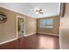 Open living room with ceiling fan, laminate flooring and views to other spaces at 1430 Rosetree Ct, Clearwater, FL 33764
