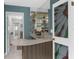 A charming wet bar that includes a mirrored wall with glass shelving and a unique stained-glass door at 1430 Rosetree Ct, Clearwater, FL 33764