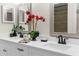 Bathroom featuring a double vanity with white countertops, dark faucets, and framed mirrors at 14645 Spellman Ct, Spring Hill, FL 34610