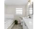 Bright bathroom featuring tub, vanity, new fixtures, and ample counter space and storage at 14645 Spellman Ct, Spring Hill, FL 34610