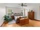Cozy bedroom featuring a comfy bed with neutral linens, wood furnishings, and bright natural light at 14645 Spellman Ct, Spring Hill, FL 34610