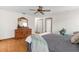 Cozy bedroom featuring a comfy bed with neutral linens, wood furnishings, and bright natural light at 14645 Spellman Ct, Spring Hill, FL 34610