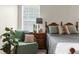 Cozy bedroom featuring a comfy bed with neutral linens, wood furnishings, and bright natural light at 14645 Spellman Ct, Spring Hill, FL 34610