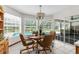 Bright breakfast nook with an outdoor view of the swimming pool and lanai at 14645 Spellman Ct, Spring Hill, FL 34610