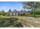 Inviting single-story home with mature trees, a cozy front yard, and classic architectural details at 14645 Spellman Ct, Spring Hill, FL 34610