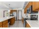 Bright kitchen featuring stainless steel appliances, wood cabinets, and white countertops at 14645 Spellman Ct, Spring Hill, FL 34610