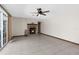 Inviting living room with brick fireplace, tile flooring, ceiling fan and natural light from sliding glass doors at 14645 Spellman Ct, Spring Hill, FL 34610