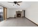 Inviting living room with brick fireplace, tile flooring, ceiling fan and natural light from sliding glass doors at 14645 Spellman Ct, Spring Hill, FL 34610