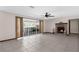 Spacious living room with tile floors, a brick fireplace, and sliding glass doors to the pool at 14645 Spellman Ct, Spring Hill, FL 34610