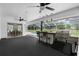 Covered outdoor kitchen area adjacent to the screened-in pool with bar seating at 14645 Spellman Ct, Spring Hill, FL 34610
