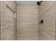 Walk-in shower with light brown, horizontally stacked tiles and a shower niche with a dark shower head at 14645 Spellman Ct, Spring Hill, FL 34610