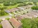 An elevated neighborhood view with charming homes, manicured lawns, and beautiful tree canopies at 15004 Middle Fairway Dr, Spring Hill, FL 34609