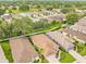 Aerial view featuring well-manicured lawns, neighborhood streets, and scenic surroundings at 15004 Middle Fairway Dr, Spring Hill, FL 34609