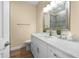 Bright bathroom features a large mirror, vanity with a sink and neutral wall paint at 15004 Middle Fairway Dr, Spring Hill, FL 34609