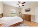 Comfortable bedroom featuring wood floors, large windows, and a ceiling fan at 15004 Middle Fairway Dr, Spring Hill, FL 34609