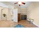 Bright bedroom with hardwood floors, built-in shelving, and an open doorway at 15004 Middle Fairway Dr, Spring Hill, FL 34609