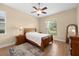 Cozy bedroom with wood floors, a ceiling fan and natural light from the window at 15004 Middle Fairway Dr, Spring Hill, FL 34609