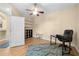 Bright bedroom featuring wood floors, built-in shelves, and a ceiling fan at 15004 Middle Fairway Dr, Spring Hill, FL 34609