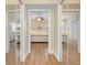 Hallway leading to bedrooms, featuring mirrored closets and wood flooring at 15004 Middle Fairway Dr, Spring Hill, FL 34609