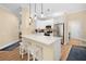 Modern kitchen with white cabinets, stainless steel appliances, and a white quartz countertop at 15004 Middle Fairway Dr, Spring Hill, FL 34609