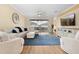 Comfortable living room with hardwood floors, ample seating, and sliding glass doors to the patio at 15004 Middle Fairway Dr, Spring Hill, FL 34609