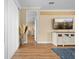 Inviting living room with wood floors, neutral walls, and a modern entertainment center at 15004 Middle Fairway Dr, Spring Hill, FL 34609