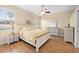 Comfortable bedroom with light-colored furniture, ceiling fan, and natural light from windows at 15004 Middle Fairway Dr, Spring Hill, FL 34609