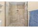Updated shower with mosaic tile accents, built-in seat, and modern fixtures at 15004 Middle Fairway Dr, Spring Hill, FL 34609