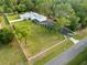 Aerial view of a home with a large, fenced yard and long driveway at 15430 Oakcrest Cir, Brooksville, FL 34604