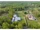 Aerial view of a property featuring a house, a large yard, and wooded surroundings at 15430 Oakcrest Cir, Brooksville, FL 34604