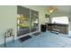 Covered back porch with hot tub and ceiling fan looking toward sliding glass doors at 15430 Oakcrest Cir, Brooksville, FL 34604