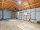Expansive barn interior featuring a roll-up door, windows, and open floor plan at 15430 Oakcrest Cir, Brooksville, FL 34604