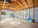 Large barn with wooden beams, windows, and ample space for storage or projects at 15430 Oakcrest Cir, Brooksville, FL 34604