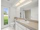 Bright bathroom with white cabinets and walk-in shower at 15430 Oakcrest Cir, Brooksville, FL 34604